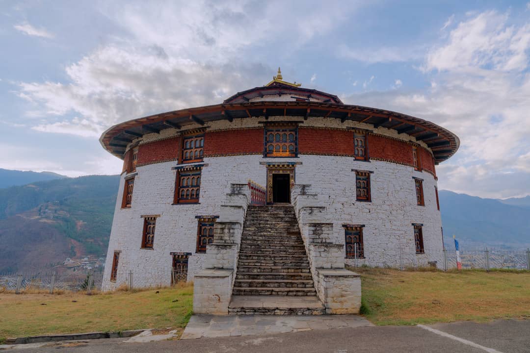 The circular National Museum building standing above Paro Valley