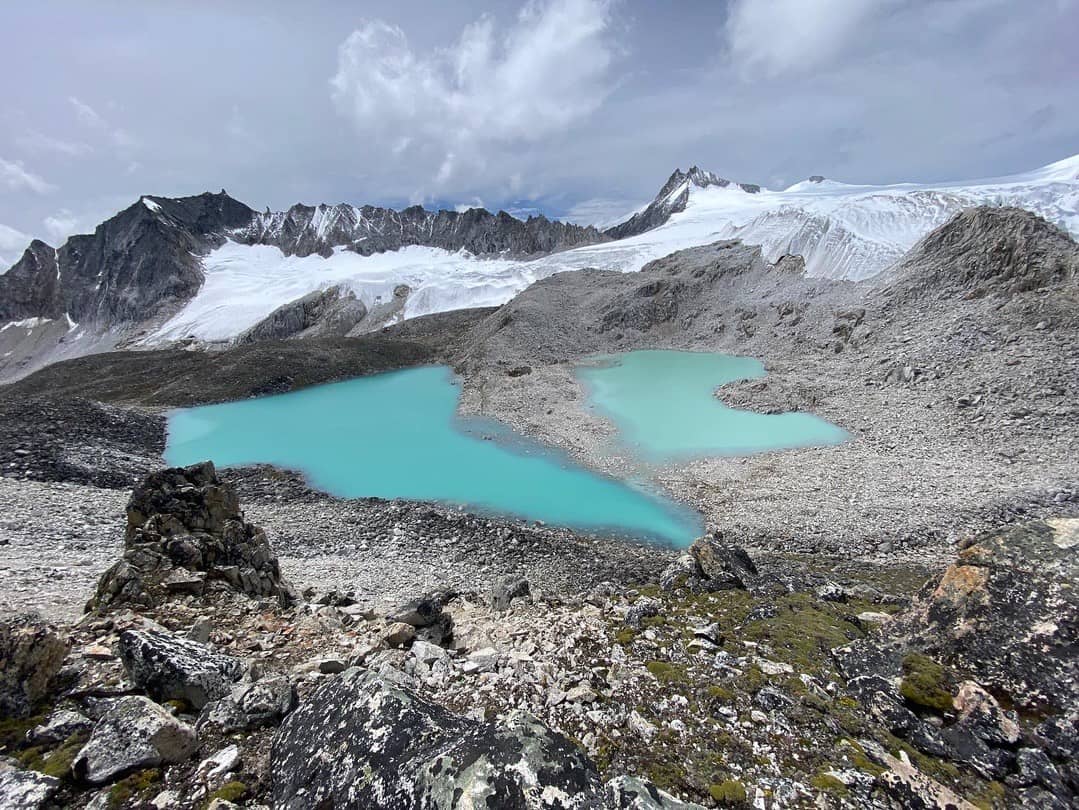 Turquoise glacial lakes beneath snow-covered peaks on Bhutan's Snowman route