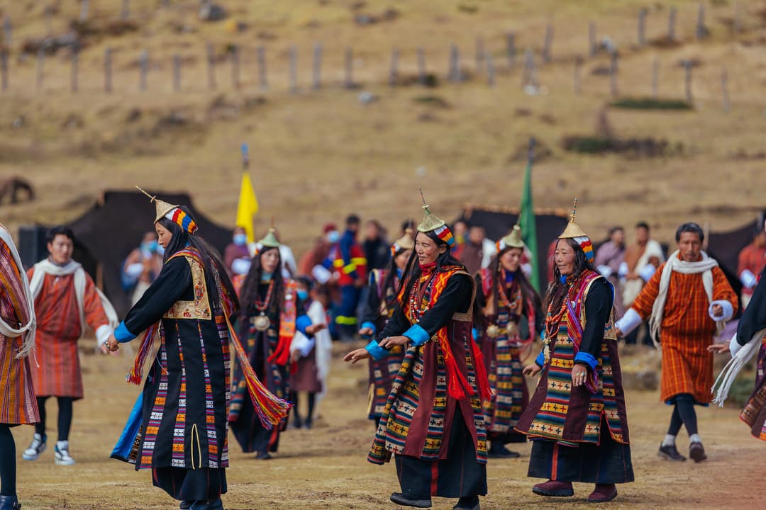 Layap women dancing in traditional dress during a highland celebration