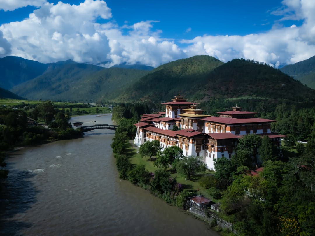 Punakha Dzong standing beside the river in its green valley