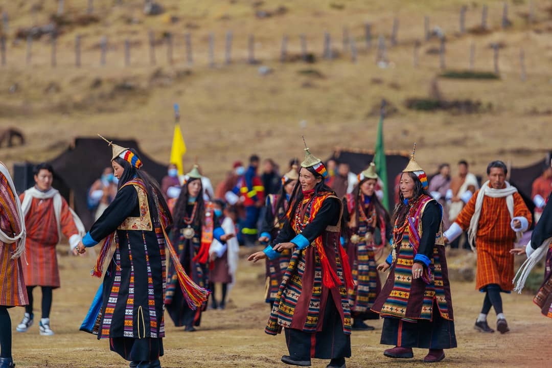 Layap women dancing in traditional dress during a highland celebration
