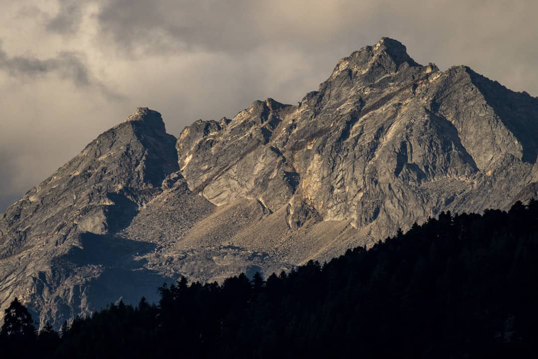 Rocky Himalayan peaks rising above the forests around Paro